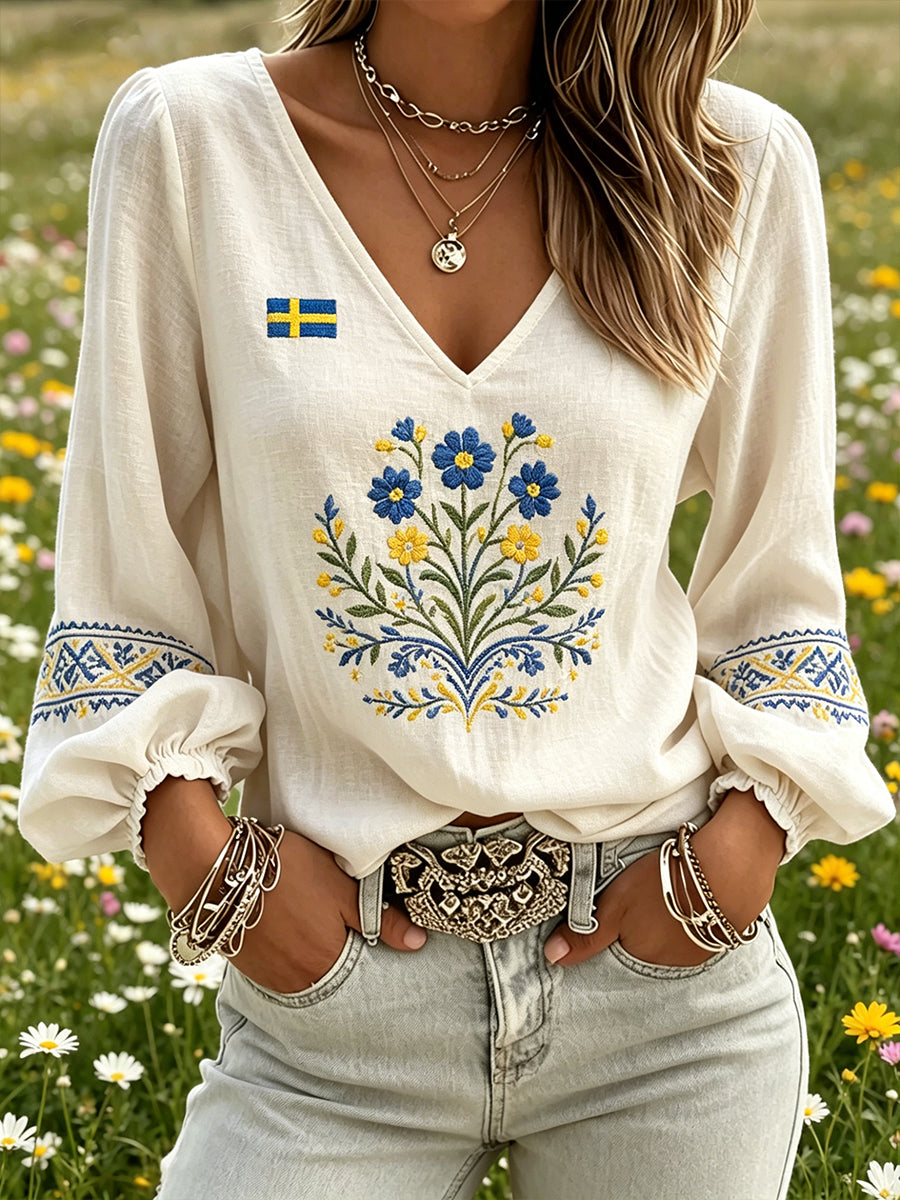 Dams topp med midsommarmotiv, blommönstrad, v-ringning och puffärmar