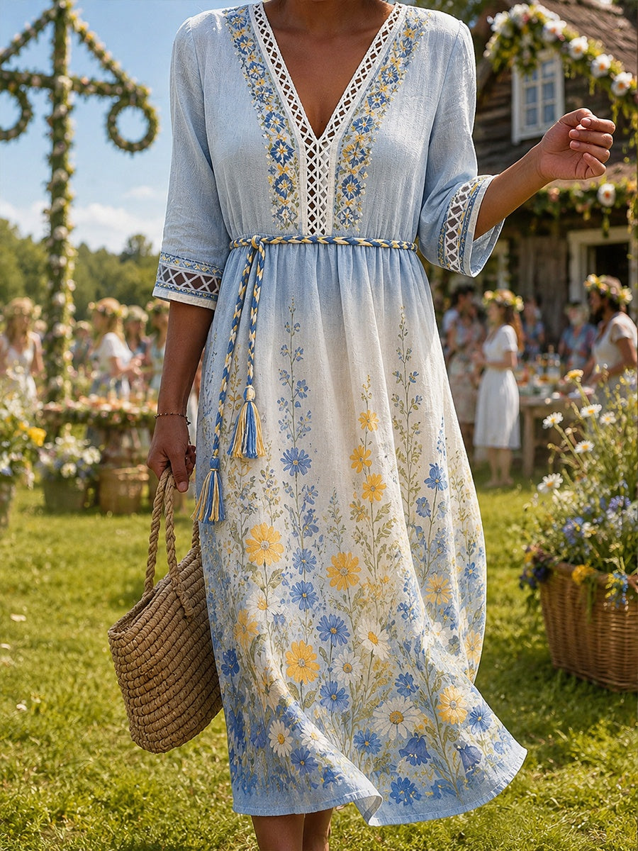 Damklänning med midsommarblommönster, v-ringning och lång ärm